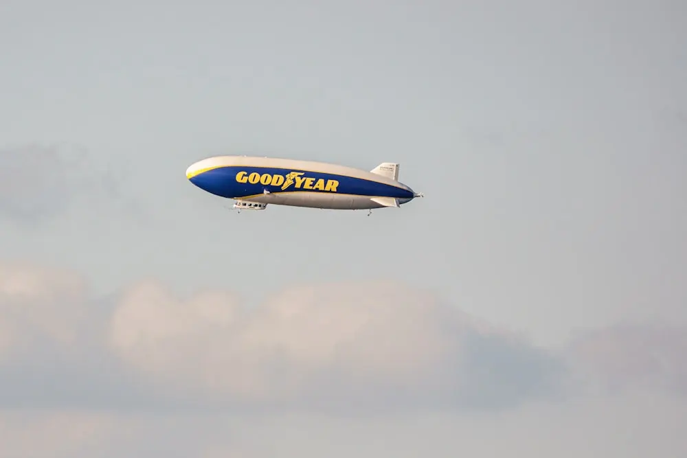 a large blue and white airplane flying in the sky